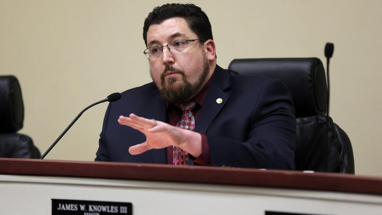 In this Feb. 2, 2016 file photo, Ferguson Mayor James Knowles III speaks during a city council meeting in Ferguson, Mo. As Ferguson leaders consider a lawsuit filed against the city by the U.S. Department of Justice, the town's effort at an amended agreement with DOJ acknowledged that losing the police department is a possibility. (Jeff Roberson / AP)