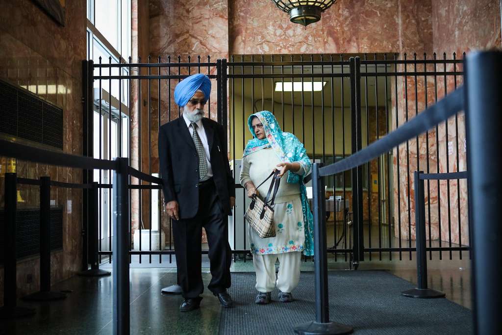 Avtar (left) and Arjinder Chahal, the parents of Gurbaksh Chahal, enter the San Francisco Hall of Justice to attend their son’s court hearing on prosecutors’ request to revoke his probation.