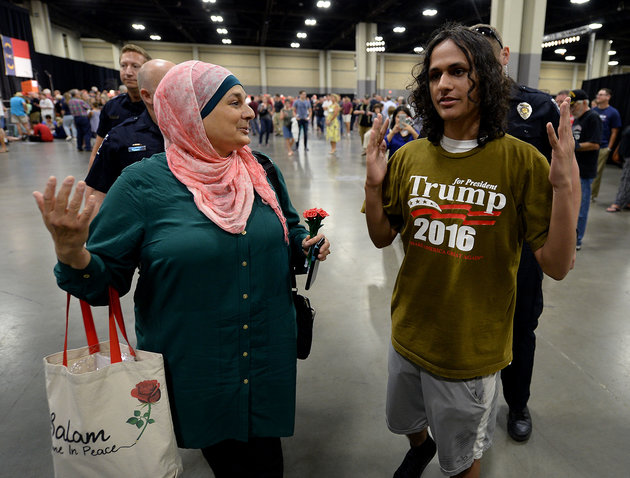 Rose Hamid, left, and Jake Anantha, right, are escorted from the Charlotte Convention Center in Charlotte, N.C., prior to a rally for GOP presidential candidate Donald Trump on Thursday, Aug. 18, 2016.